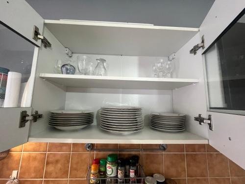a kitchen with plates and dishes on shelves at Deux chambres Terrasse salle de sport in Vigneulles-lès-Hattonchâtel