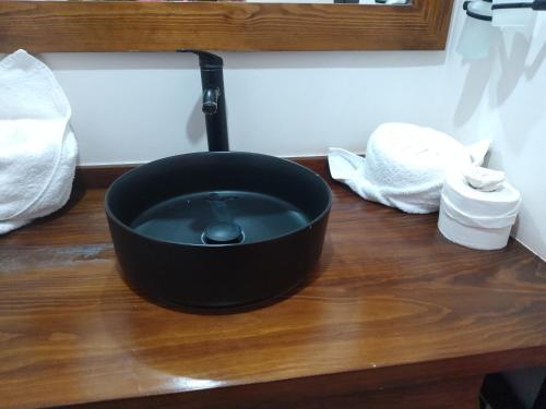 a black pot sitting on top of a wooden table at Lidia Anturios Suites in Oaxaca City
