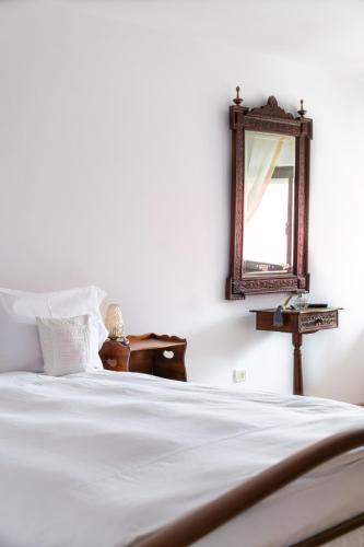 a bedroom with a bed with a mirror on the wall at Casa Maria in Bran