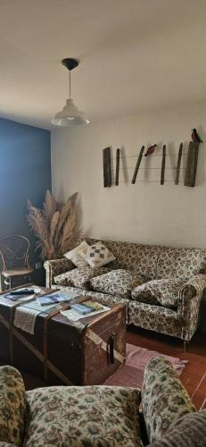 a living room with a couch and a table at Casa Eike in El Calafate