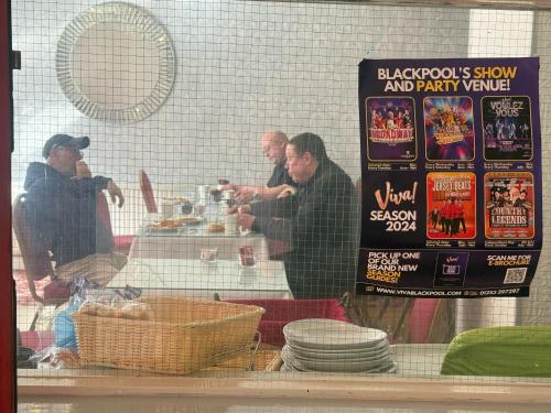 a group of men standing at a table in a store window at The Aberford in Blackpool