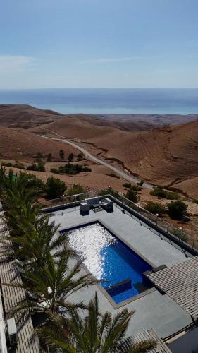 an overhead view of a swimming pool and the ocean at Golden rays chalet in Madaba