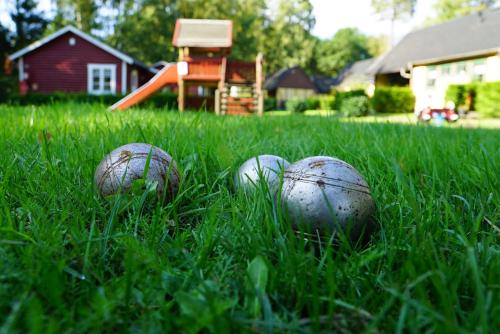 four balls in the grass in a yard at Ystad Holiday Houses in Ystad