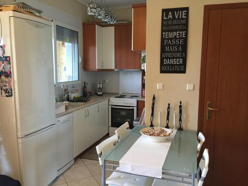 a kitchen with a table with a bowl of food on it at POSSIDI - Ithaki Holiday Apartments in Kalandra