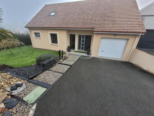 Chambre bardney في La Bazoge: منزل به مرآب وممر سيارات