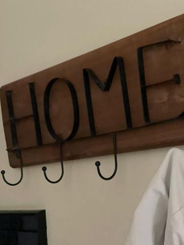 a sign that reads open hanging on a wall at The Guest Apartment 2025 in Fier