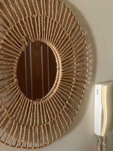 a mirror hanging on a wall next to a phone at The Guest Apartment 2025 in Fier