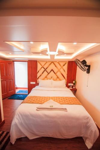 a bedroom with a large bed in a room at Kera Houseboats Alleppey in Alleppey