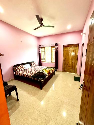 a bedroom with a bed and a ceiling fan at Kumaon Lake's Home stay in Nainital