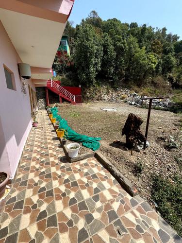 a yard with a group of chairs and a house at Kumaon Lake's Home stay in Nainital