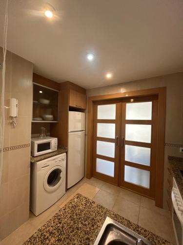 a kitchen with a washer and dryer in it at Torremar Living in Oropesa del Mar