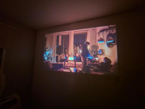 a person standing in a living room with a tv at Apto Ipiranga 1 Quarto com vaga de garagem in Sao Paulo