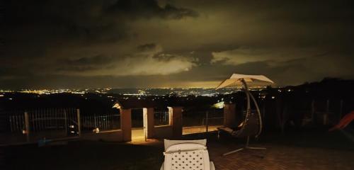 a patio with an umbrella and chairs at night at I 4 bimbi in Borgomale