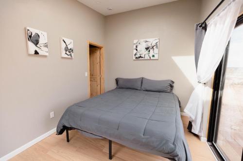 a bedroom with a bed and a window at Grand Canyon Stargazing Off-Grid in Williams