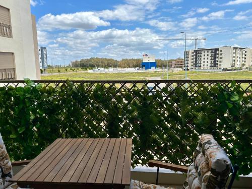 a wooden table sitting on top of a balcony at AeroRelax, free Parking, WI-FI in Nouaseur