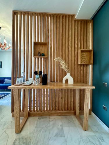a wooden table in a room with a wall at AeroRelax, free Parking, WI-FI in Nouaseur