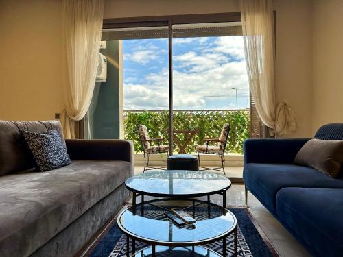 a living room with a couch and a table at AeroRelax, free Parking, WI-FI in Nouaseur