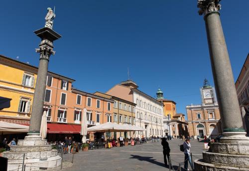 a town square with a clock tower and buildings at In Piazza 'Apartments & Relax' in Ravenna