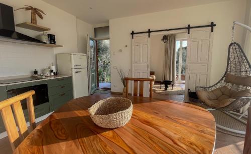 a kitchen with a wooden table and a swing at HomeTerra in Brenzone sul Garda
