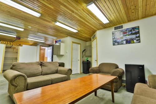a living room with a couch and a table at Dog friendly Home on Ski Hill with Hot Tub by StayIn in Fernie