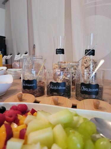 a table topped with glasses of different types of food at Gästehaus Fechtig in Hergensweiler