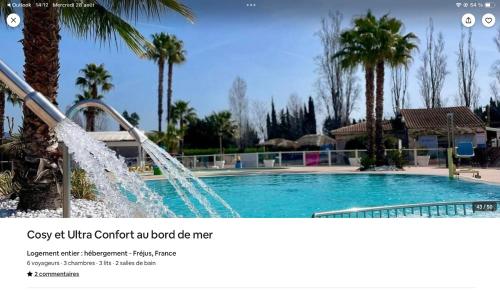 a picture of a swimming pool with a fountain at cosy et ultra confort au bord in Fréjus