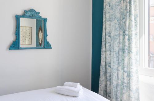 a room with a bed with a mirror and a window at In Piazza 'Apartments & Relax' in Ravenna