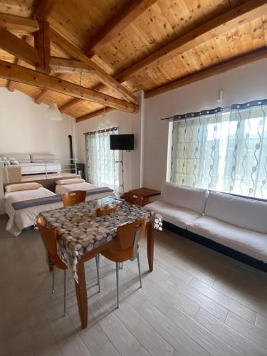 a living room with a table and a couch at Happy Nest in Sulmona