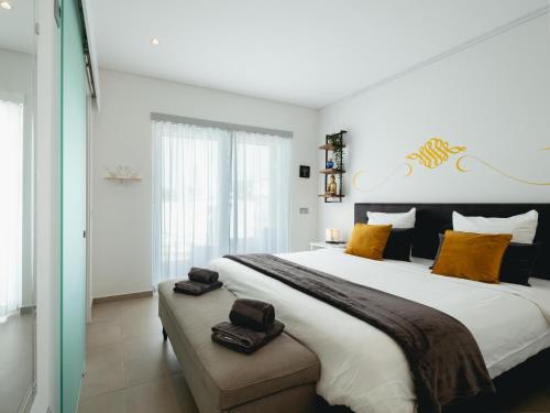 a bedroom with a large bed with orange pillows at Cazenn Salir do Porto - Holiday house in Salir de Porto