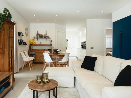 a living room with a white couch and a table at Cazenn Salir do Porto - Holiday house in Salir de Porto