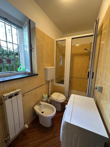 a small bathroom with a toilet and a sink at Bilocale Voltri Mare 4 posti in Genova