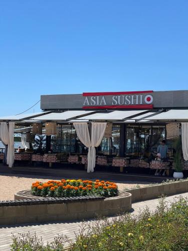 an asia substitute store with flowers in front of it at Квартира на Иссык-куле в ЦО Радуга in Chon-Sary-Oy