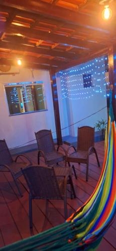 a group of chairs and a hammock on a patio at Casa completa com área gourmet e piscina -2 quartos in Macapá