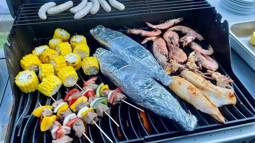 a grill with different types of seafood and vegetables at 2-min from Private Beach Sanctuary Villa Ho Tram in Ho Tram