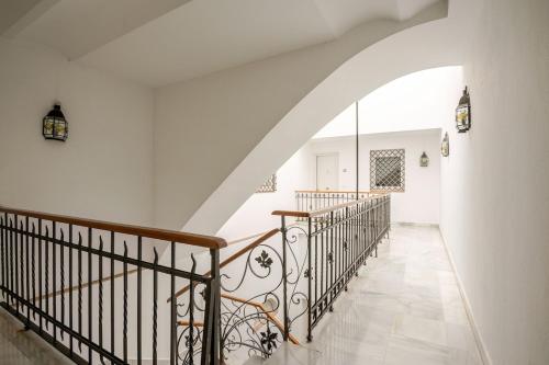 a staircase in a home with white walls and a stair case at TYP Sevilla in Seville