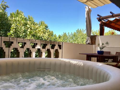 a jacuzzi tub in a backyard with a table at TYP Sevilla in Seville