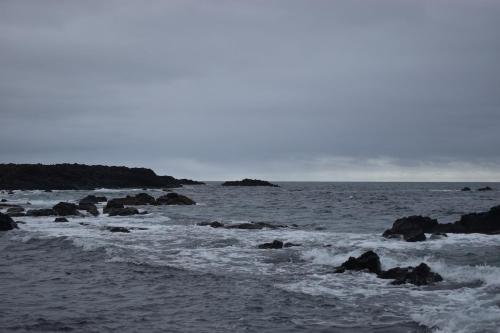a body of water with rocks in the ocean at Casa Cruzeiro AL - by the sea OCEANTUR in Rosário-Lagoa