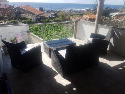 a balcony with chairs and a view of the ocean at Casa Cruzeiro AL - by the sea OCEANTUR in Rosário-Lagoa