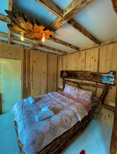 a bedroom with a bed in a room with wooden walls at VALLEY SUiT OTEL in Rize