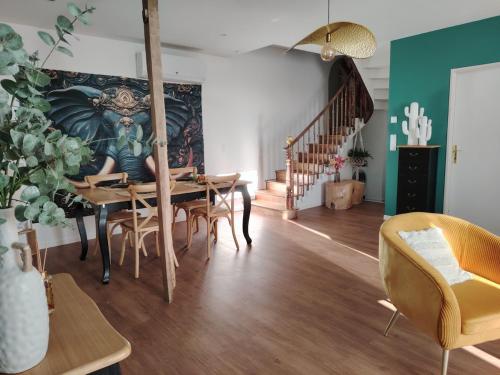 a dining room with a table and chairs at La Tour XVIII in Sarrouilles