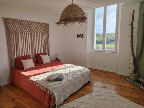 a bedroom with a bed and a large window at La Tour XVIII in Sarrouilles