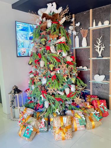 a christmas tree with presents under it at Hotel Pacific in Tijuana
