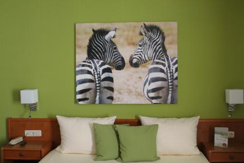 two zebras standing next to each other in a bedroom at Hotel Rüdesheimer Hof in Rüdesheim am Rhein