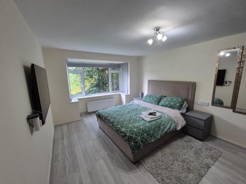 a bedroom with a bed and a window at Lovely & Beautiful 2 Bed-Apartment in Borehamwood in Borehamwood