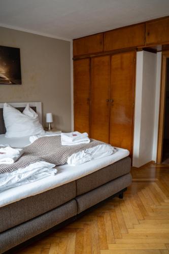 a bedroom with a large bed with wooden cabinets at WuhrsteinHaus, Heil- und Seminarzentrum Chiemgau in Schleching
