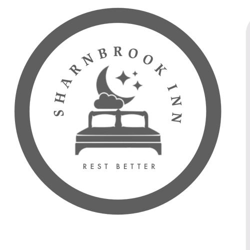 a black and white logo for a restaurant with the moon and stars at SHARNBROOK INN Hotel Restaurant Bar Perfect For Santa Pod in Bedford