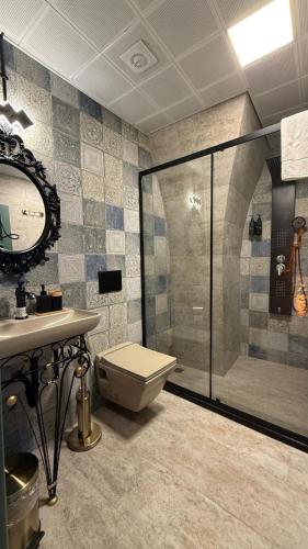 a bathroom with a shower and a toilet and a sink at Liora Hotel in Urfa