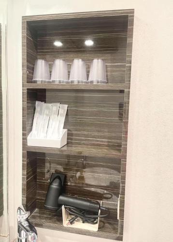 a cupboard with a black phone and a box at Hotel Arashi Shinsaibashi No001 in Osaka