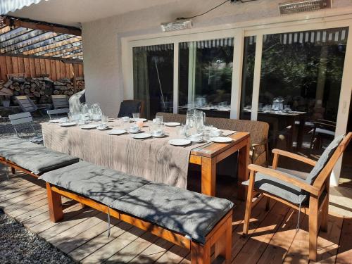 a table with glasses on it on a patio at WuhrsteinHaus, Heil- und Seminarzentrum Chiemgau in Schleching