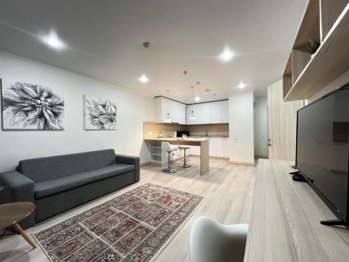 a living room with a couch and a table at Y'ES APART Astana in Astana